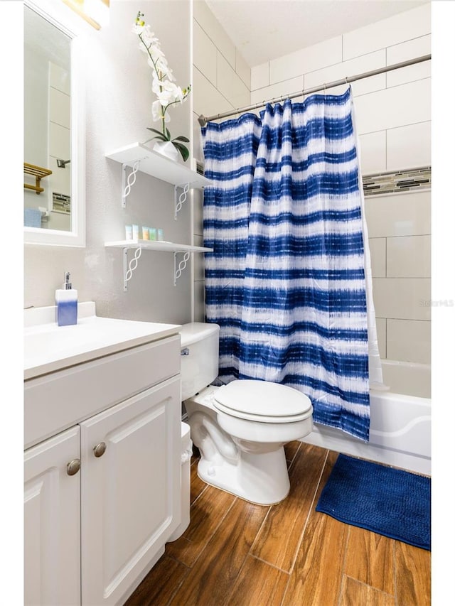 full bathroom with hardwood / wood-style floors, vanity, toilet, and shower / bathtub combination with curtain