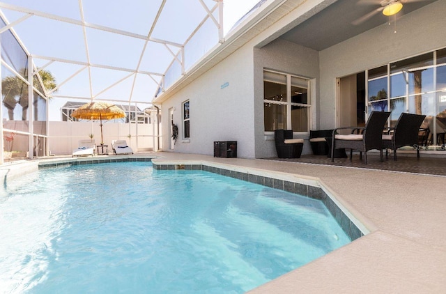 view of swimming pool featuring a lanai and a patio