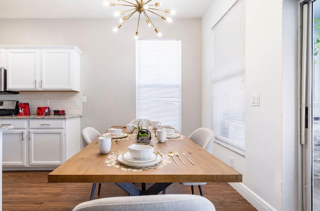 dining room with dark hardwood / wood-style flooring, a chandelier, and plenty of natural light