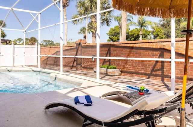 view of pool with a patio area and a lanai