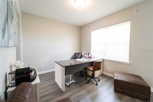 office featuring a textured ceiling and dark hardwood / wood-style flooring