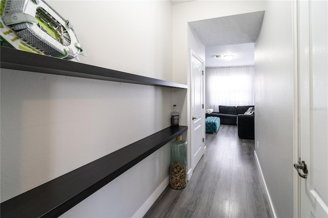 hall featuring dark hardwood / wood-style flooring and a textured ceiling