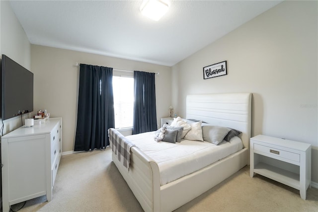 carpeted bedroom featuring vaulted ceiling