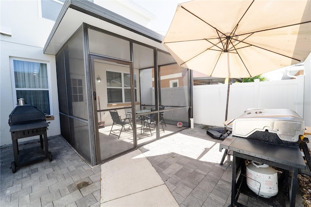 view of patio / terrace featuring a sunroom