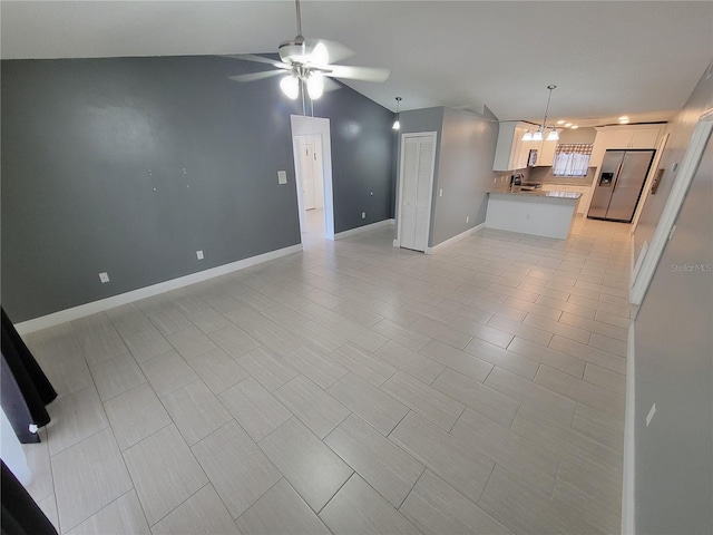 unfurnished living room with ceiling fan and lofted ceiling