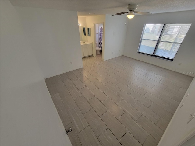 spare room featuring ceiling fan and light wood-type flooring