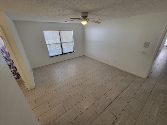 spare room featuring a textured ceiling and ceiling fan