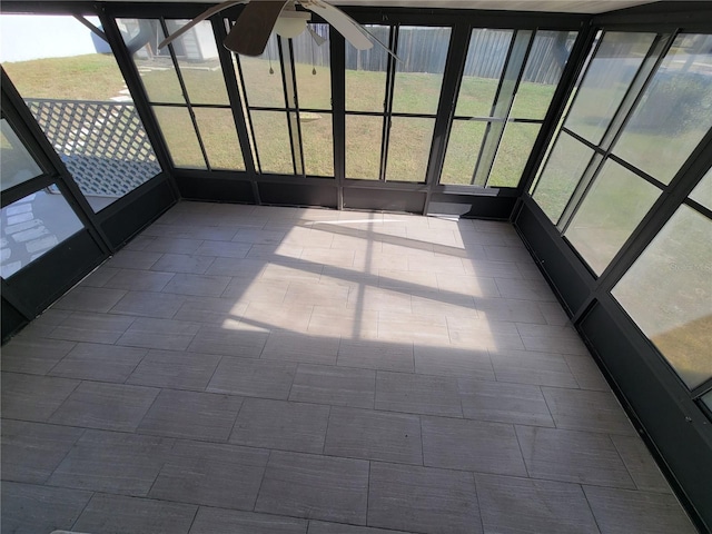 unfurnished sunroom with ceiling fan