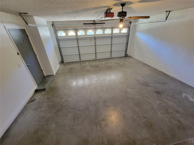 garage with ceiling fan and a garage door opener