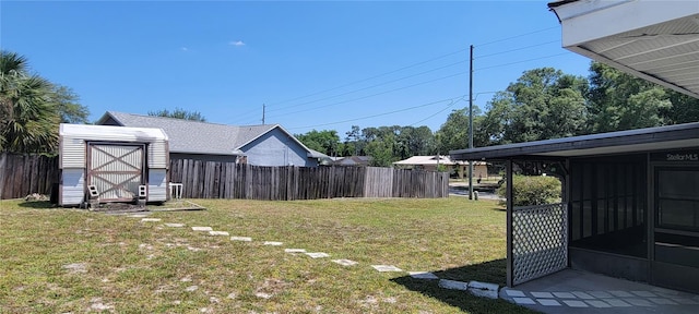 view of yard with a shed and a sunroom