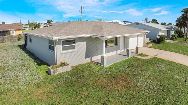 rear view of house with a yard and a garage