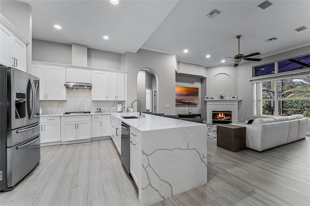 kitchen featuring white cabinets, kitchen peninsula, stainless steel appliances, and sink