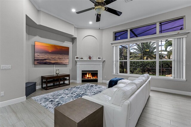 living room featuring ornamental molding, ceiling fan, and light hardwood / wood-style floors