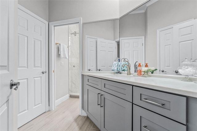 bathroom featuring a shower, wood-type flooring, and vanity