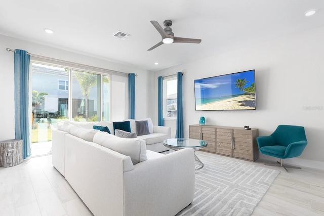 living room with a wealth of natural light and ceiling fan