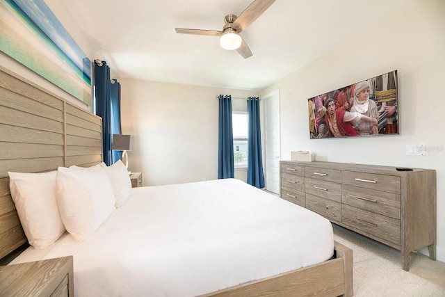 bedroom with light carpet and ceiling fan