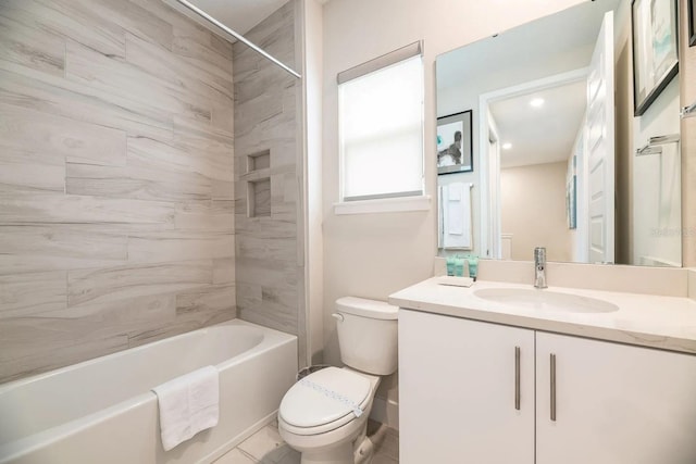 full bathroom featuring tile patterned floors, vanity, toilet, and tiled shower / bath combo