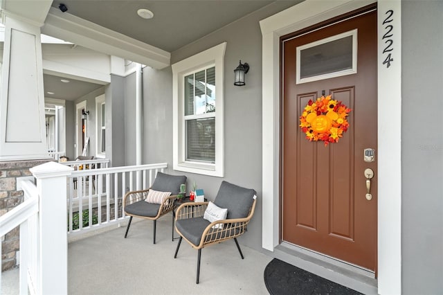 view of exterior entry featuring covered porch