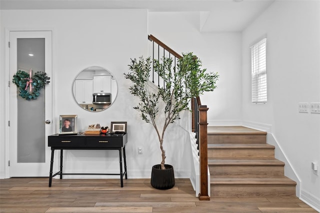 staircase with hardwood / wood-style flooring