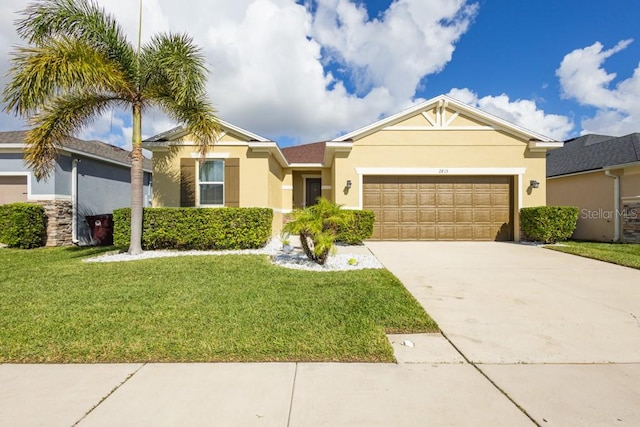 view of front of property with a garage and a front lawn