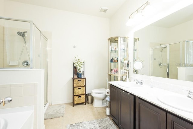 full bathroom featuring tile patterned flooring, shower with separate bathtub, vanity, and toilet