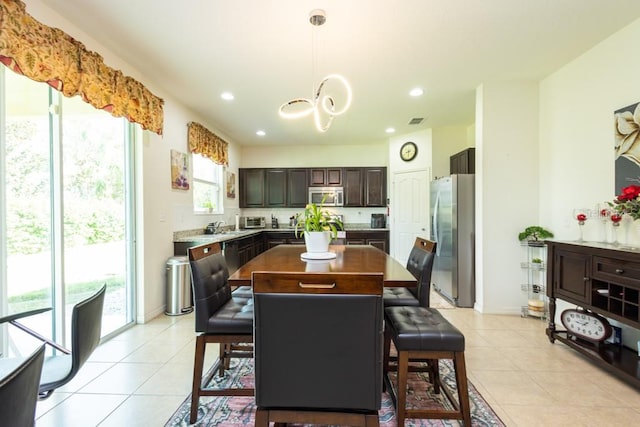 dining room with light tile patterned floors and sink