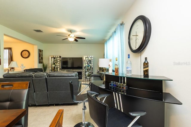 living room featuring ceiling fan and light tile patterned floors