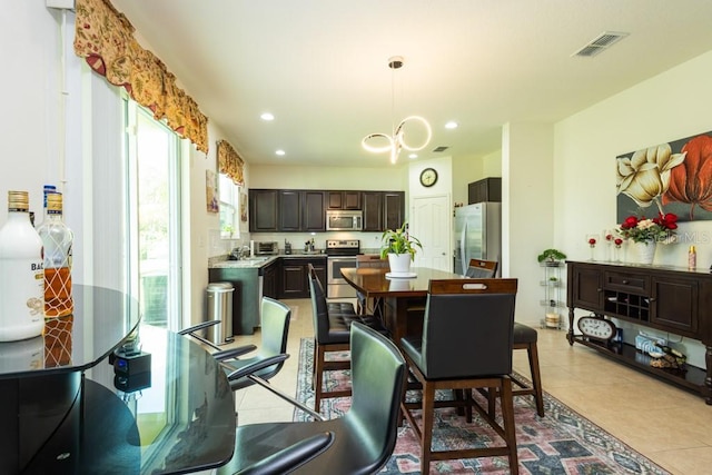 dining space with a wealth of natural light and light tile patterned floors