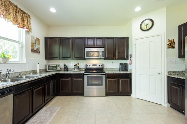 kitchen with dark brown cabinets, appliances with stainless steel finishes, and sink