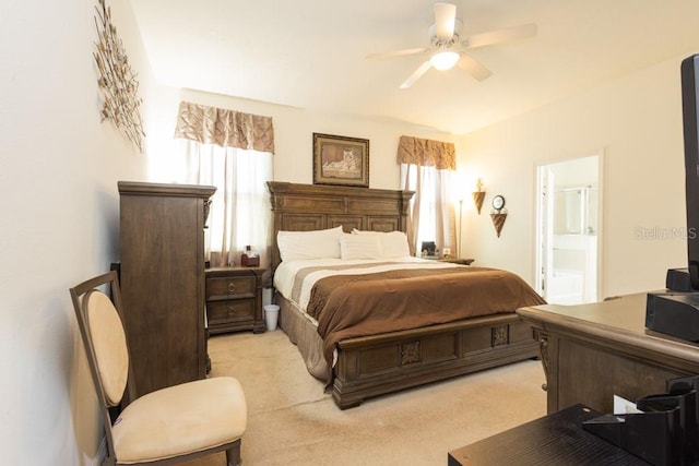 bedroom with ceiling fan, connected bathroom, and light colored carpet