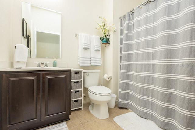 bathroom featuring toilet, vanity, and tile patterned floors