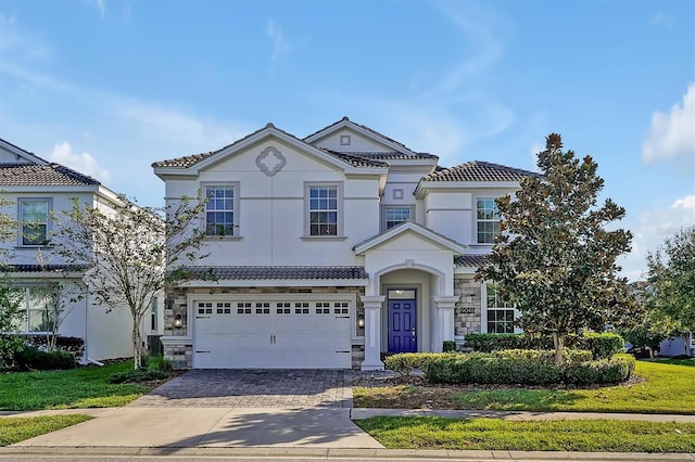 view of front of property with a garage and a front yard