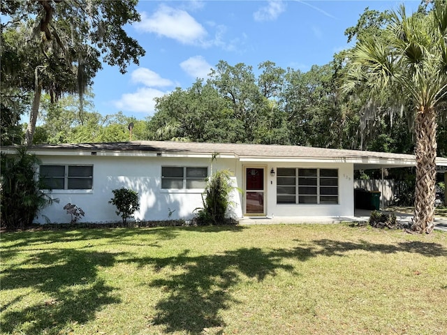 single story home featuring stucco siding and a front yard