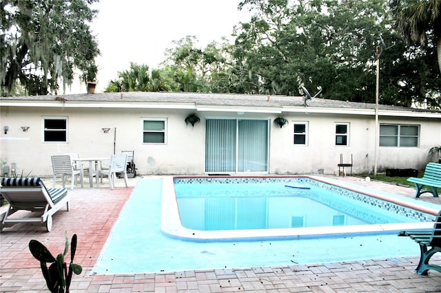 outdoor pool with a patio area