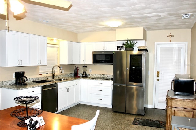 kitchen with white cabinets, black appliances, and a sink