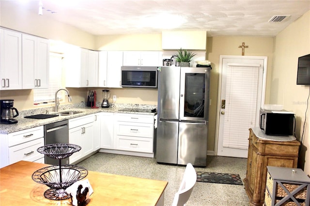 kitchen with white cabinetry, visible vents, appliances with stainless steel finishes, and a sink
