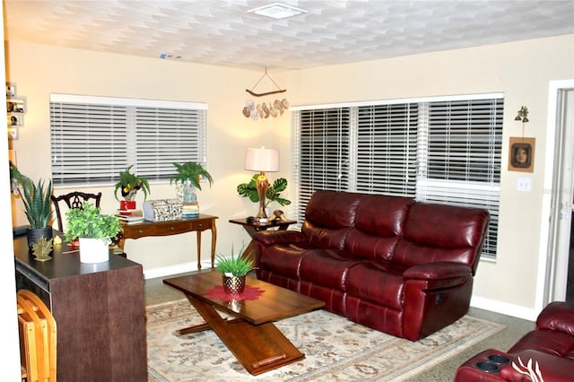 carpeted living room with baseboards and visible vents