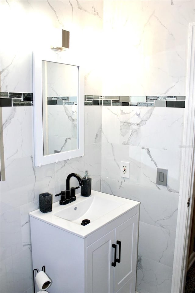 bathroom featuring tile walls and vanity