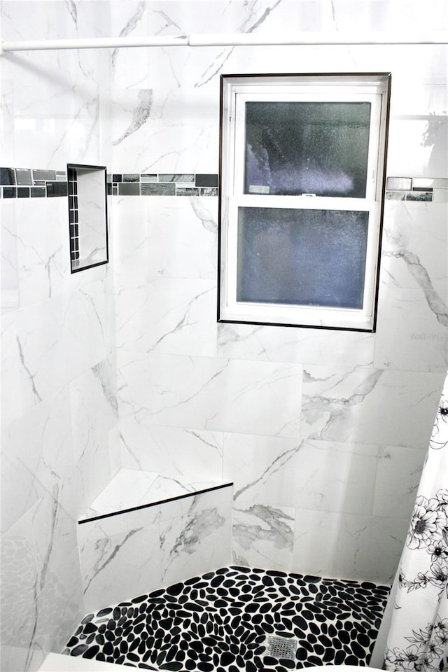 full bath with tiled shower