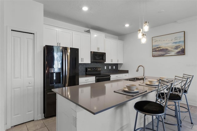 kitchen with black appliances, white cabinets, sink, and a kitchen island with sink