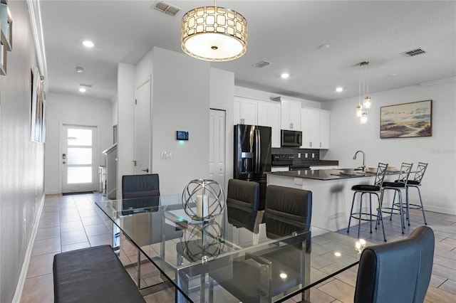 dining area featuring light hardwood / wood-style flooring and sink