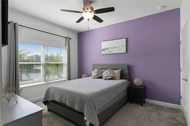 bedroom with ceiling fan and carpet flooring