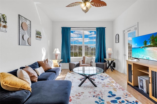 living room featuring light hardwood / wood-style floors and ceiling fan