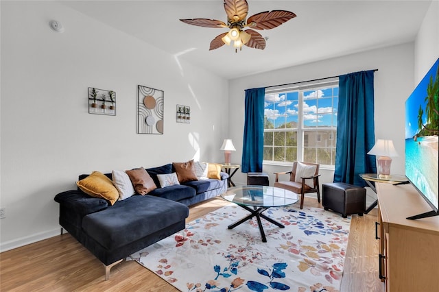 living room featuring wood-type flooring and ceiling fan