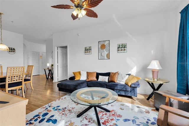 living room featuring hardwood / wood-style flooring and ceiling fan