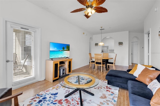 living room featuring ceiling fan and light hardwood / wood-style flooring