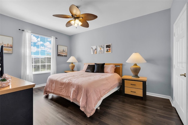 bedroom with dark hardwood / wood-style flooring and ceiling fan