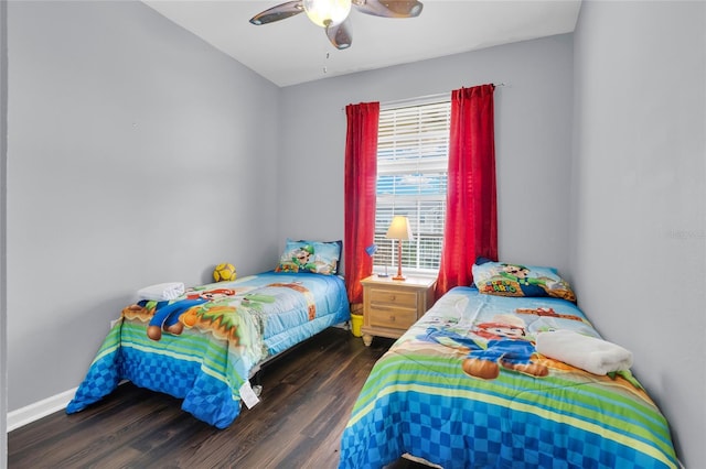 bedroom with ceiling fan and dark hardwood / wood-style flooring