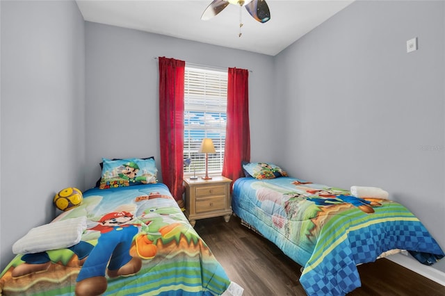 bedroom featuring multiple windows, ceiling fan, and dark hardwood / wood-style flooring