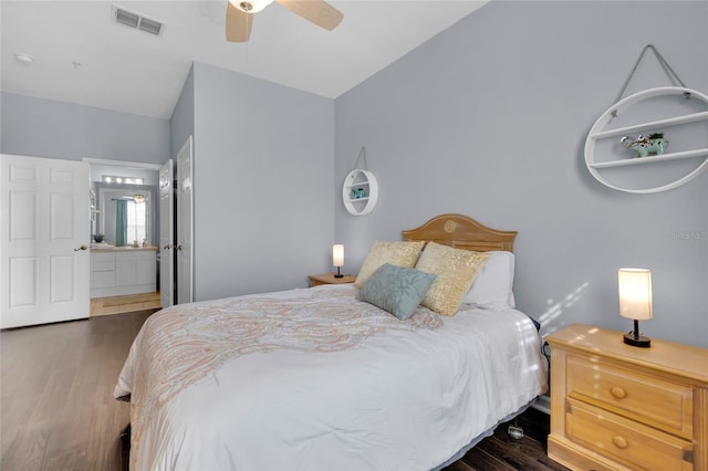 bedroom featuring connected bathroom, ceiling fan, dark wood-type flooring, and lofted ceiling